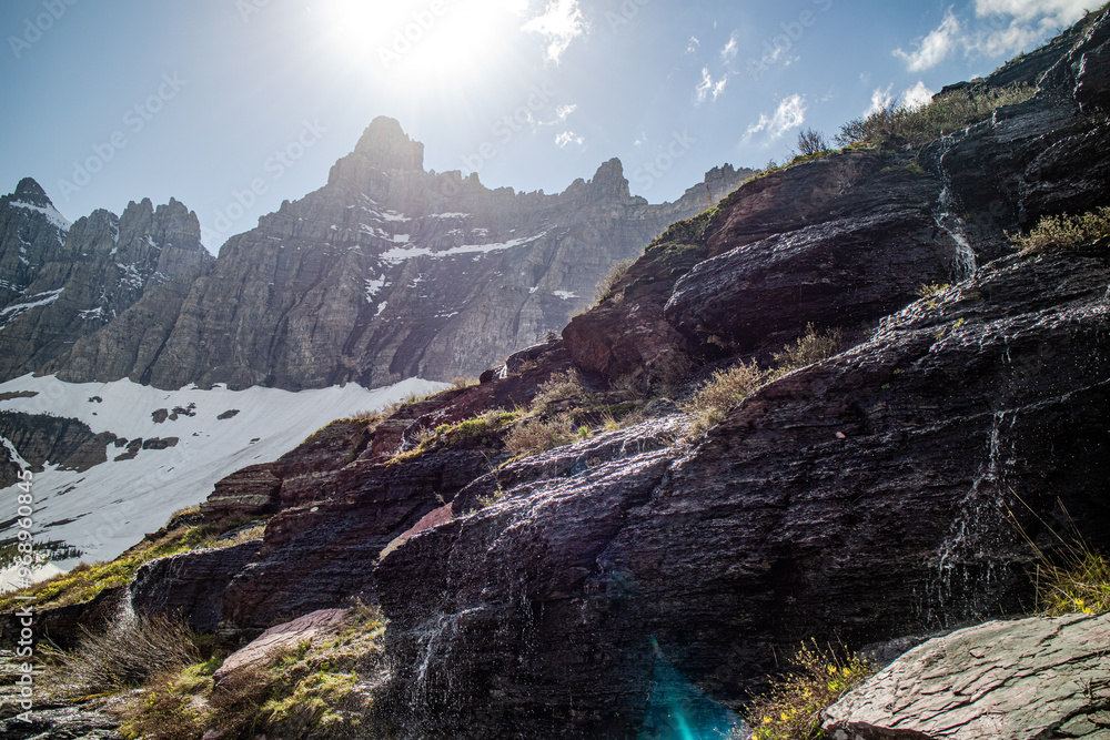Obraz premium Iceberg lake at the Glacier national park, Montana, USA. Hiking trail is the most beautiful scenery of the u shape valley and covered with snow.
