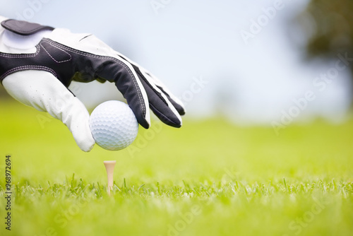 Person, place ball and hands on golf course, club and outdoor fitness for competition or games. Gloves, tournament and precision tee for practice match on field, position and professional athlete photo