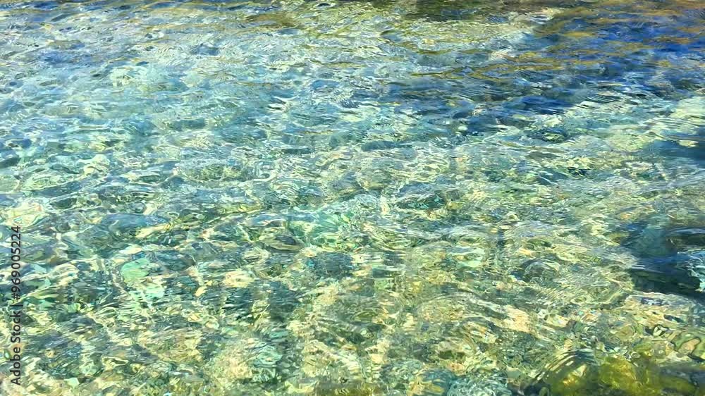 Shallow clear water revealing stones on the seabed at Marinella Beach, Corsica. Shallow clear water revealing stones on the seabed at Marinella Beach, Corsica.
