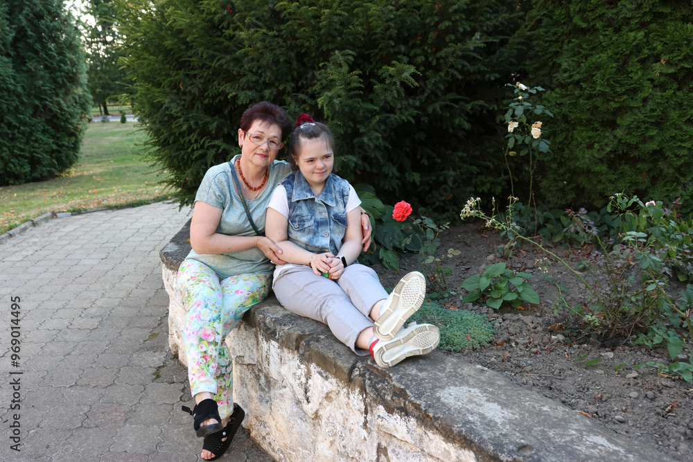 Fototapeta premium A mother walks with her daughter with Down syndrome.
