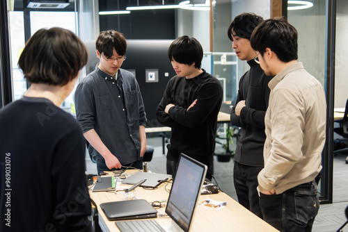 Wallpaper Mural A team of engineers discussing a solution to a technical problem in a project about machine learning systems, a group portrait reflects cooperation and innovation in a modern work environment. Torontodigital.ca