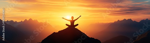 A single person in a yoga pose sits on a mountain peak with a golden sunset behind them.