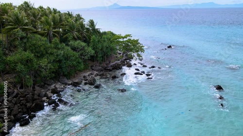 Sea Waves Splashing Rocks on a Beach from Low Altitude