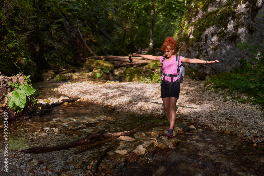Obraz premium Woman hiker by the river