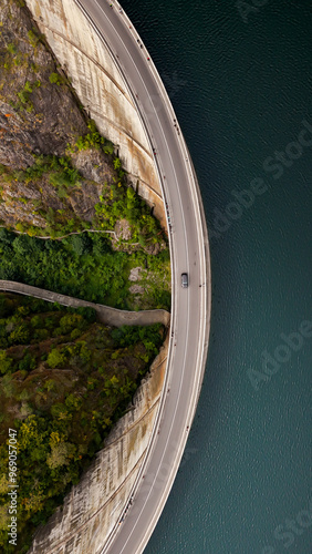 Carpathian mountains with Vidraru dam and lake. Top cinematic aerial view. Romania, Transfagaras road. The most famous and beautiful road in the Europe