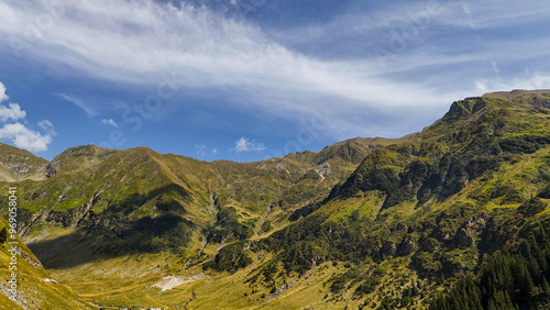 Top cinematic aerial view to the Transfagaras famous curvy road in Romania. Aerial view of Transfagarasan road in Fagarash Mountain. photo