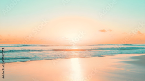 Bright orange sunset over a pale blue sky reflecting on a serene beach with gentle waves lapping at the shore