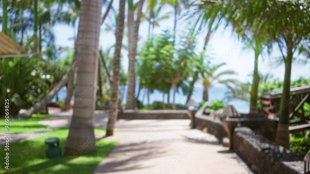 Blurred tropical resort with palm trees and ocean view in the background, highlighting a serene and defocused vacation setting. Blurred tropical resort with palm trees and ocean view in the background, highlighting a serene and defocused vacation setting.
