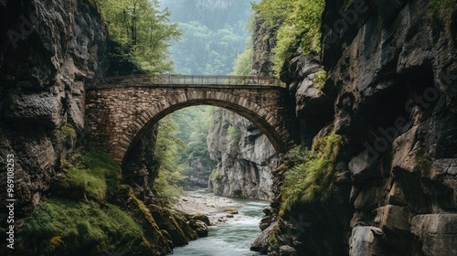 A scenic bridge framed by dramatic cliffs on either side of a narrow river gorge.