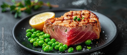 Wallpaper Mural Tuna steak cooked medium rare with peas isolated on a black background viewed from the side. with copy space image. Place for adding text or design Torontodigital.ca