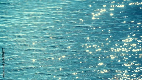 Sun reflecting and sparkling on blue sea water surface. Nature background
