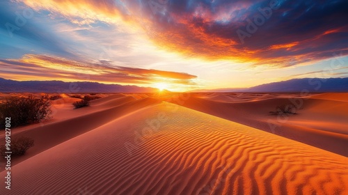 A stunning desert landscape at sunset, showcasing vibrant colors and rippled sand dunes.