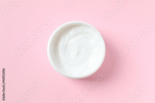 Moisturizing care skincare face cream for healing complicated troubled skin type in an open jar with visible texture photo