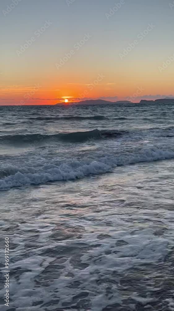 Scenic view of waves rushing at sandy beach against sky during sunset Scenic view of waves rushing at sandy beach against sky during sunset