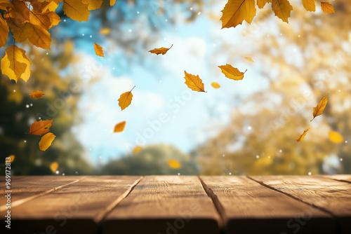Wooden table with an autumn background and blurred golden-yellow bokeh light, with falling leaves in the air
