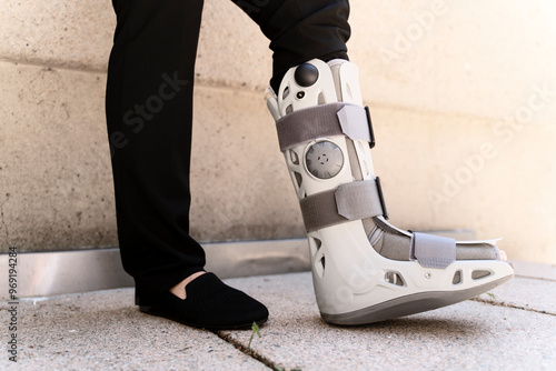 Bilde på lerret Businesswoman wearing ankle brace standing outdoors