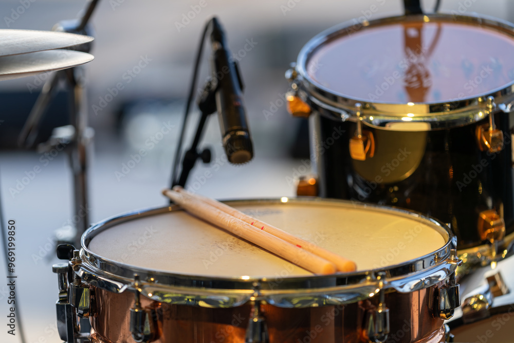 Drums set up on an open-air concert stage, ready for live performance Drums set up on an open-air concert stage, ready for live performance