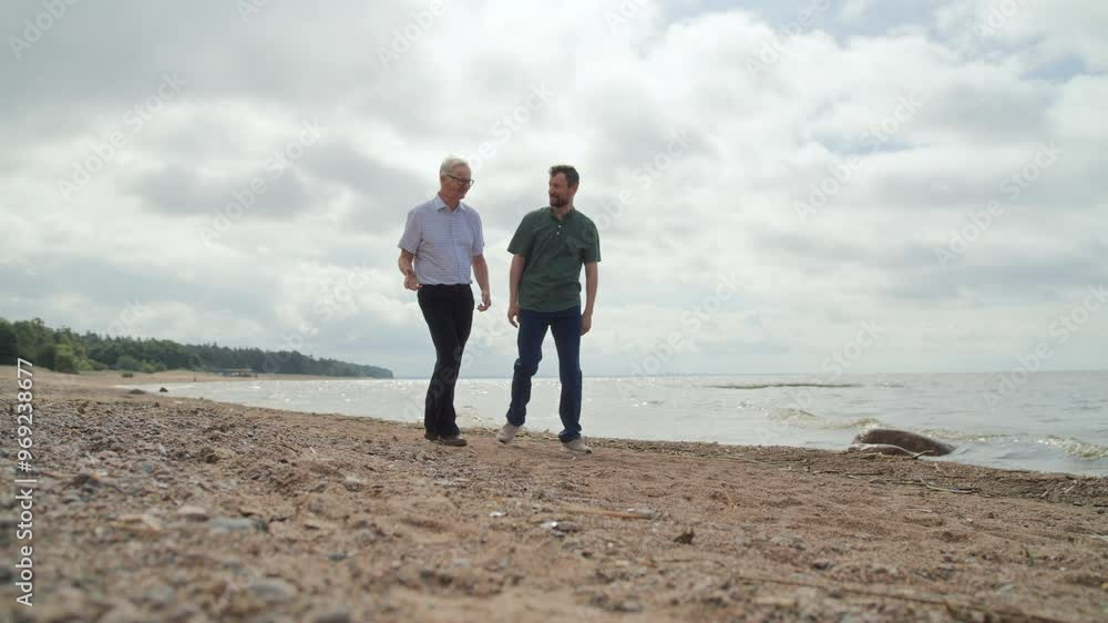 Adult son and elderly father walking together Adult son and elderly father walking together