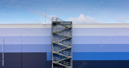 Obraz na płótnie External, evacuation staircase outside the industrial hall made of sandwich panels. Photo taken on a sunny day w salonie