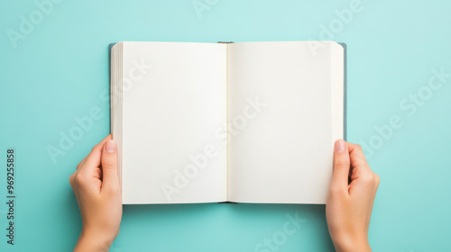 A person is opening book with blank pages, ready to write their thoughts and ideas. serene turquoise background enhances feeling of creativity and inspiration
