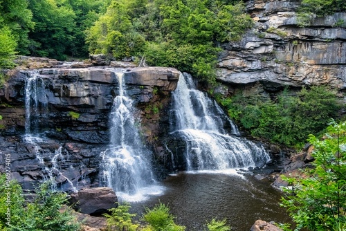 Stunning Blackwater Falls State Park cascading over rocky cliffs surrounded by lush green forest photo