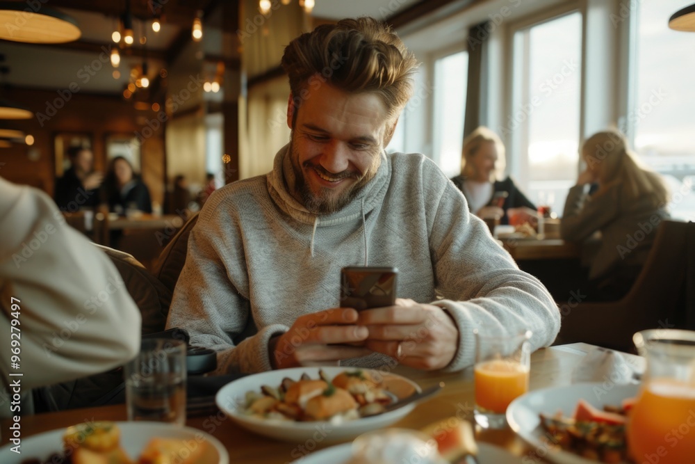 A person sitting at a desk or table staring at their mobile device A person sitting at a desk or table staring at their mobile device