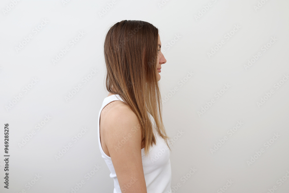 Profile view of young woman demonstrating her problematic long damaged hair, unhealthy, messy, isolated on background. Girl problem hair-type. Spit ends dry over-brushing hairstyle. Haircare concept Profile view of young woman demonstrating her problematic long damaged hair, unhealthy, messy, isolated on background. Girl problem hair-type. Spit ends dry over-brushing hairstyle. Haircare concept