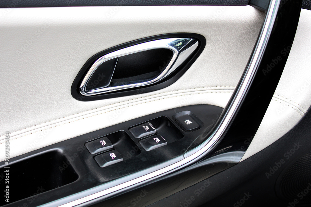 Side door buttons: window, mirror adjustment buttons, door lock. Driver lacquered Door handle with windows controls and adjustments in black white leather interior. Premium car white leather interior. Side door buttons: window, mirror adjustment buttons, door lock. Driver lacquered Door handle with windows controls and adjustments in black white leather interior. Premium car white leather interior.