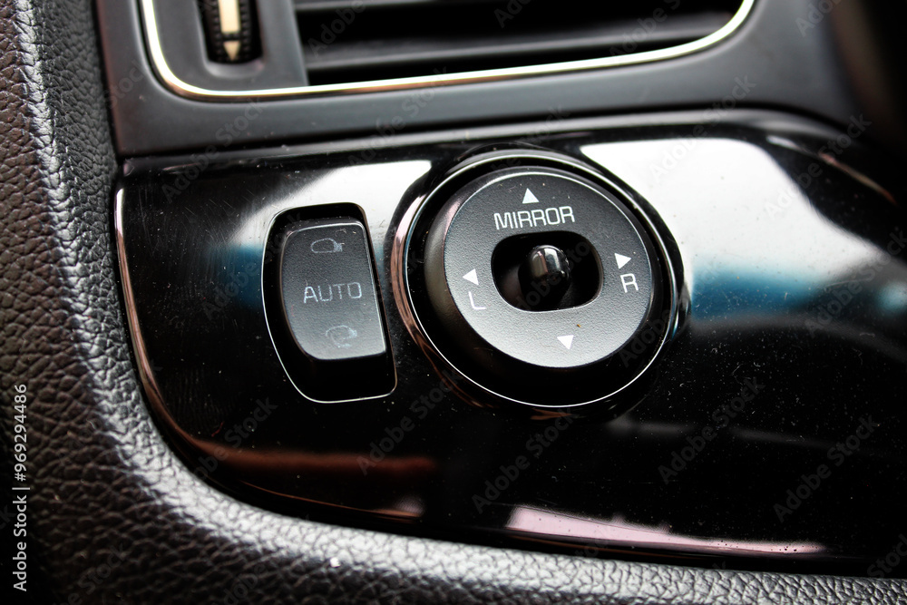 Rear view mirror adjustment. Windows controls in car interior. Control position of rear view mirrors in car interior. Selector for choosing between left and right mirror. Correct angle for the mirrors Rear view mirror adjustment. Windows controls in car interior. Control position of rear view mirrors in car interior. Selector for choosing between left and right mirror. Correct angle for the mirrors