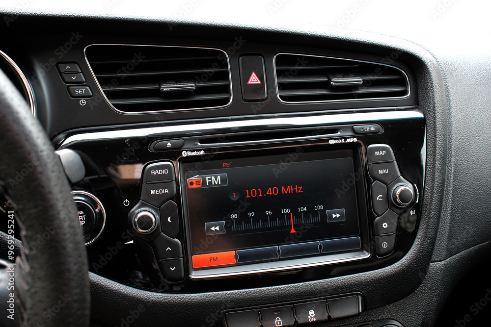 Monitor on dashboard of car in FM receiver. Controlling volume in car. Modern car multimedia. Detail of the car interior. Monitor on dashboard of car in FM receiver. Controlling volume in car. Modern car multimedia. Detail of the car interior.