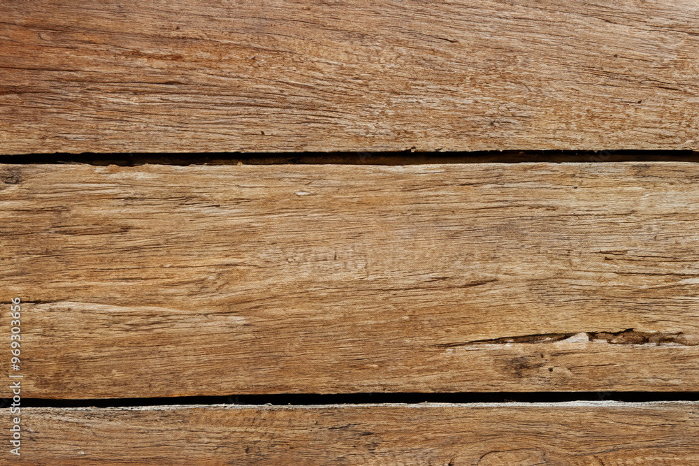 Close-up of a weathered wooden surface with natural grain and cracks. Close-up of a weathered wooden surface with natural grain and cracks.
