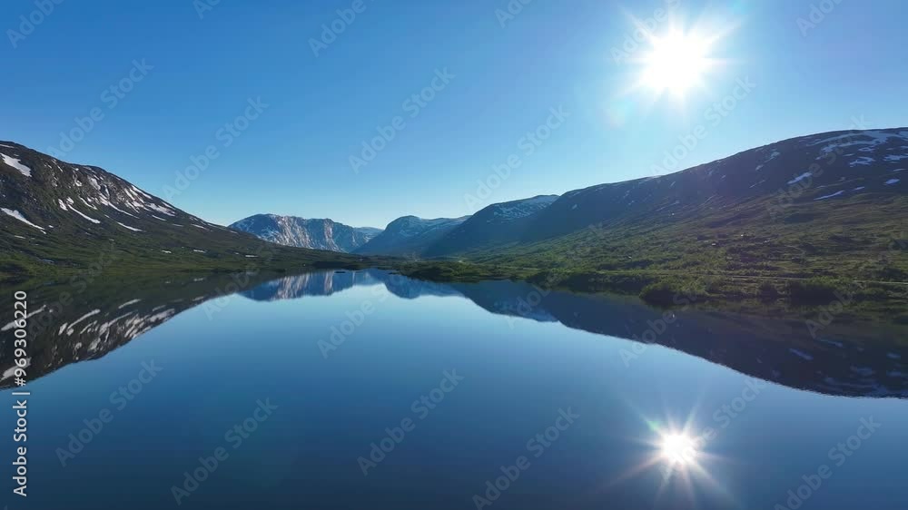 Drone view of Otta river on a sunny day surrounded by mountains with reflection in water in Norway Drone view of Otta river on a sunny day surrounded by mountains with reflection in water in Norway