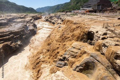 Hukou Waterfall on the Yellow River with tourists observing photo