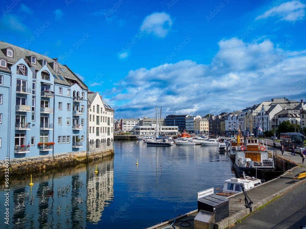 Fototapeta premium Norway with colorful buildings and a clear blue sky reflecting on the water.