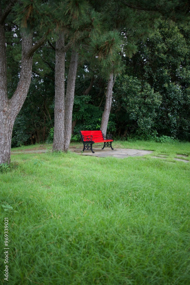 Serene park scene with red bench and trees Serene park scene with red bench and trees
