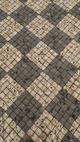 Wallpaper Mural Old checkered stone pavement forming geometric pattern in Prague. Vertical mobile photo Torontodigital.ca