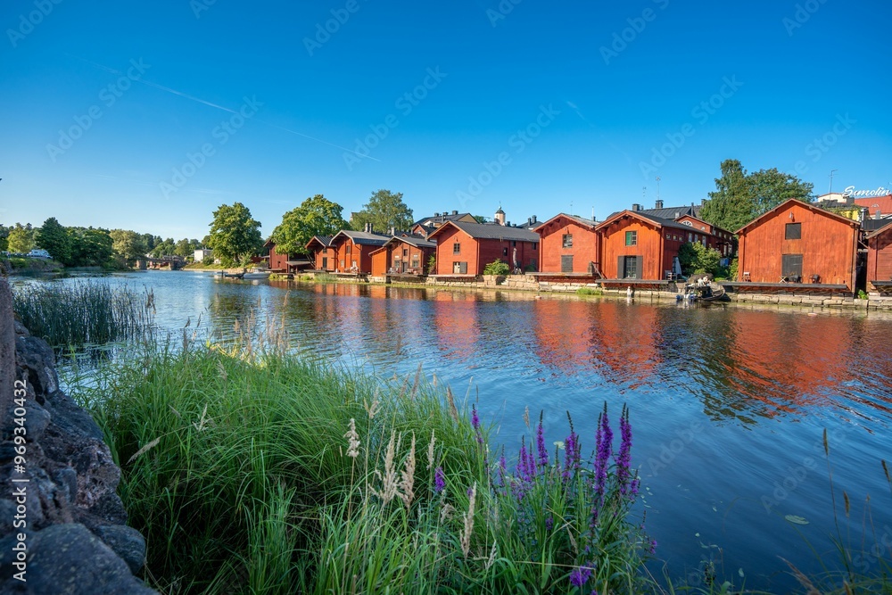 Fototapeta premium Traditional red wooden houses along the river in Porvoo, Finland