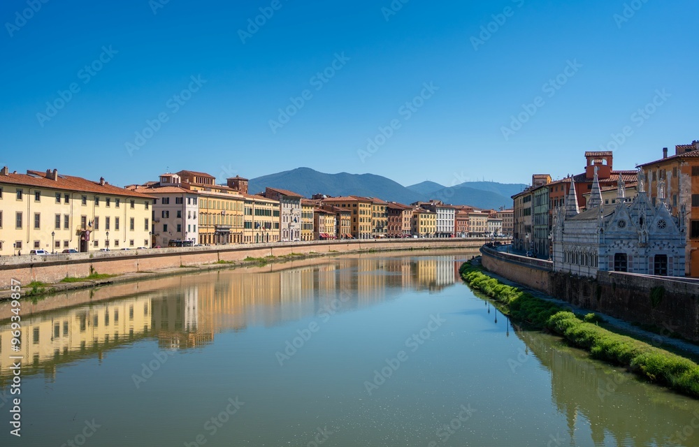 Scenic view of Arno River and historic buildings in Pisa, Italy. Scenic view of Arno River and historic buildings in Pisa, Italy.