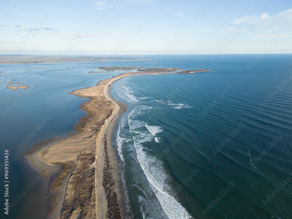 Fototapeta premium Aerial view of a coastal landscape with sandy beach and blue ocean