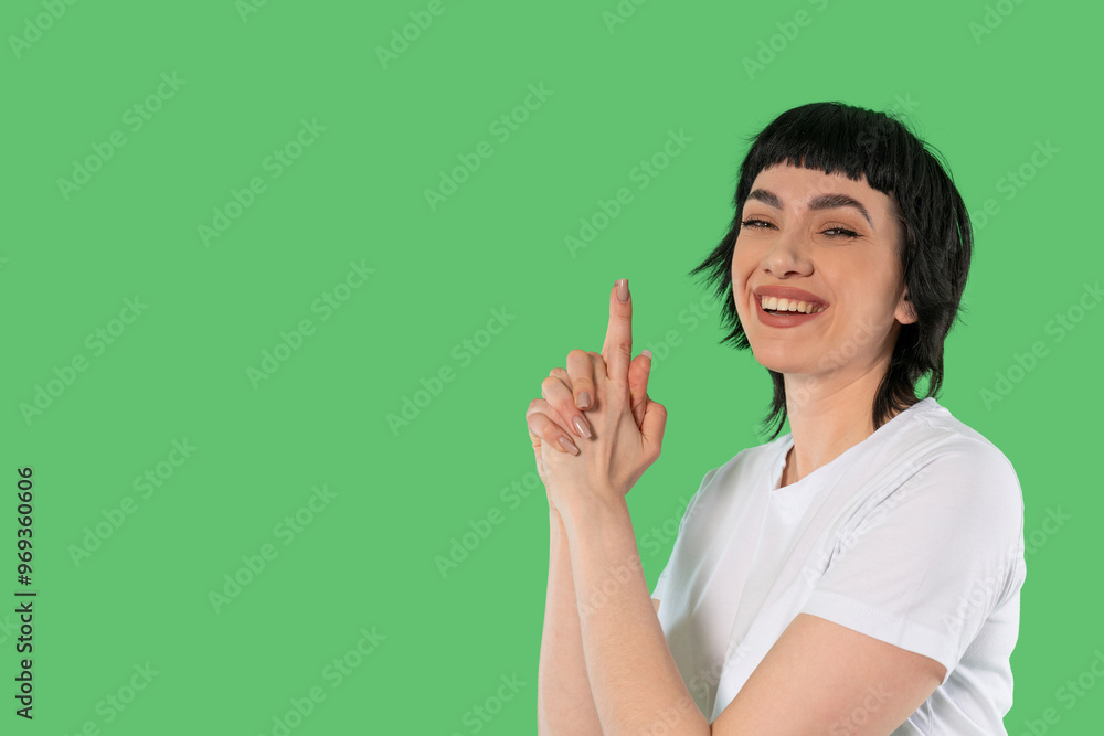 Cheerful Woman Playfully Strikes Pose Against Vivid Green Backdrop in Bright Setting Cheerful Woman Playfully Strikes Pose Against Vivid Green Backdrop in Bright Setting