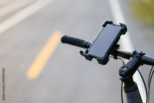 Billede på lærred Closeup smartphone in a quick release attached on the handlebar of a bicycle whi