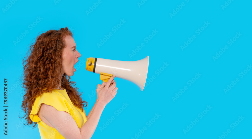 Joyful Woman Amplifying Her Voice With Megaphone Against Vibrant Blue Background