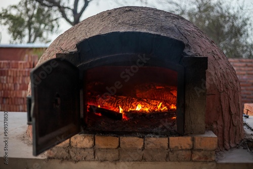 Traditional brick oven with a burning fire. photo