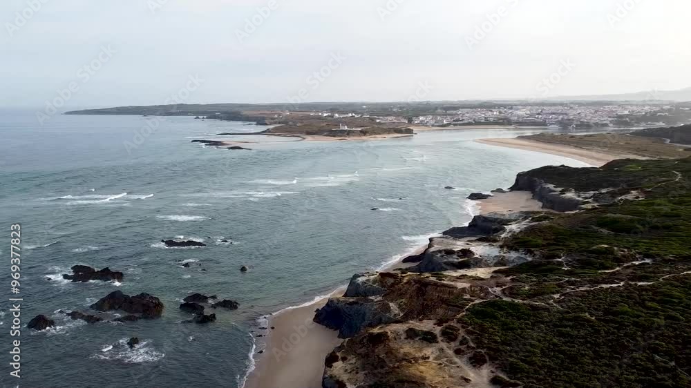 Cliffs of Vila Nova de Milfontes, Portugal, with the ocean waves and coastline. Cliffs of Vila Nova de Milfontes, Portugal, with the ocean waves and coastline.