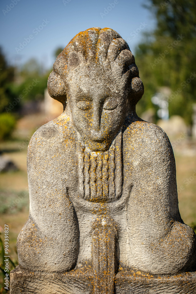 The figure of the ancient gods on the stones in the autumn park. Ukraine. Scythian culture
