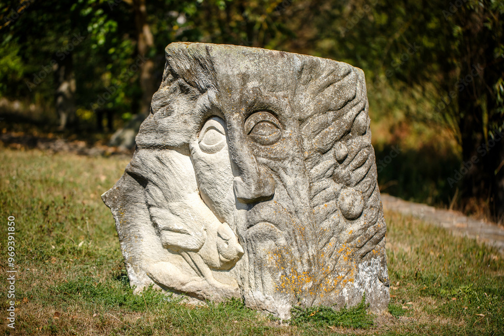 The figure of the ancient gods on the stones in the autumn park. Ukraine. Scythian culture