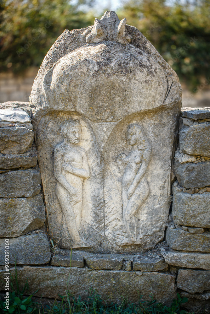 The figure of the ancient gods on the stones in the autumn park. Ukraine. Scythian culture