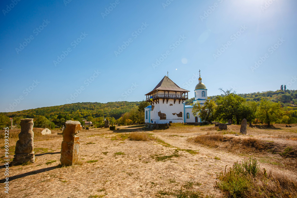 Blue Church and Old Tower in an open air nature reserve. Bush village. Ukraine
