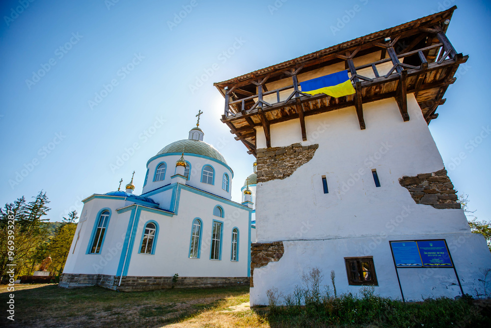 Blue Church and Old Tower in an open air nature reserve. Bush village. Ukraine