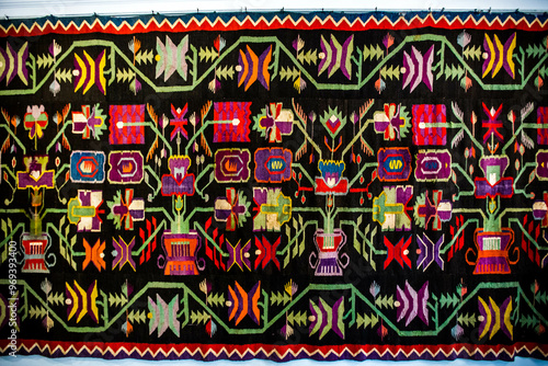 Obraz na płótnie Ornament of traditional Ukrainian multicolored colorful rug. Hutsul ethnic woven smooth hand-woven wool rug with geometric ornaments background and texture. Detail of authentic local motif carpet. w salonie
